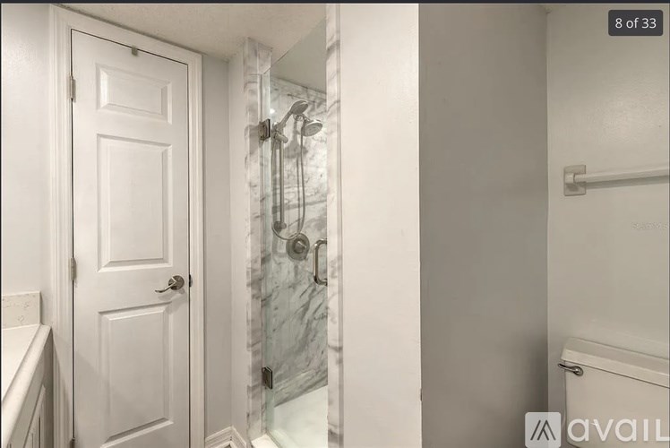 A white door is on the left and a white toilet is on the right.