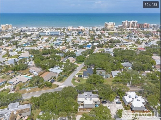 A bird's eye view of a residential area with houses and trees.