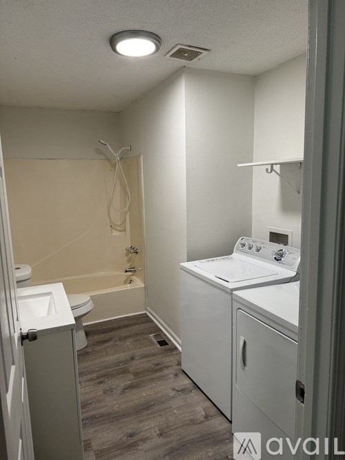 A bathroom with a toilet, sink, and bathtub.