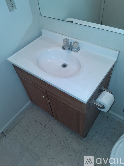 A white bathtub with a shower head and a faucet.