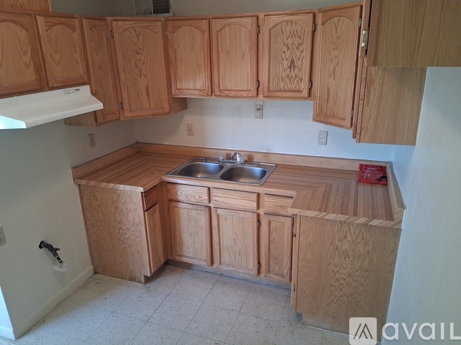 A kitchen with wooden cabinets and a sink.