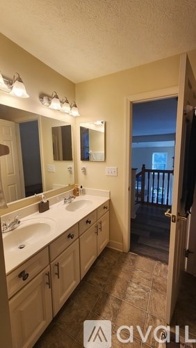 A bathroom with a sink and mirror.