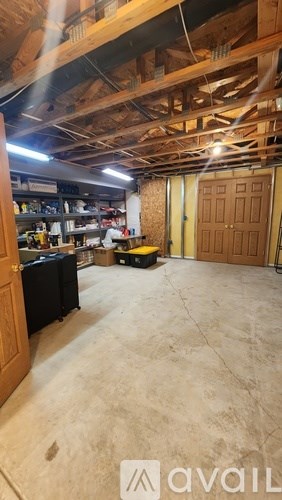 A room with a wooden ceiling and a concrete floor.