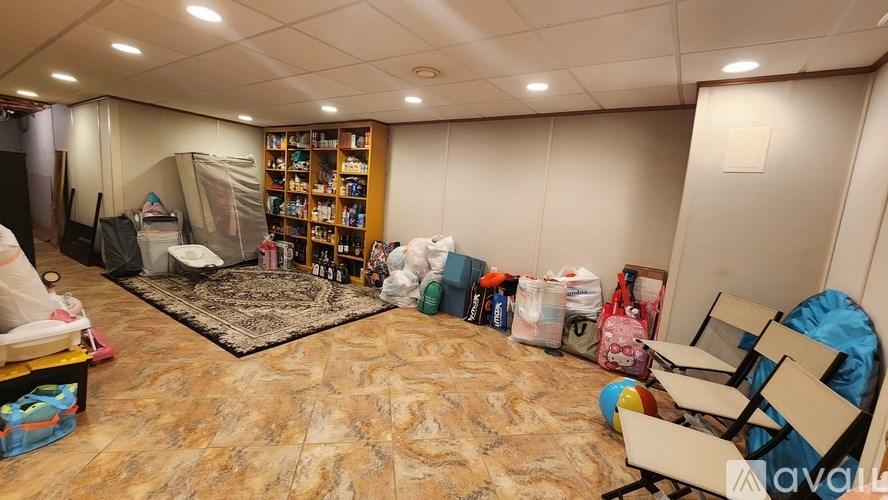 A room with a lot of clutter and a chair in it.