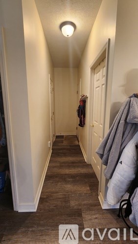 A hallway with a coat hanging on the wall.