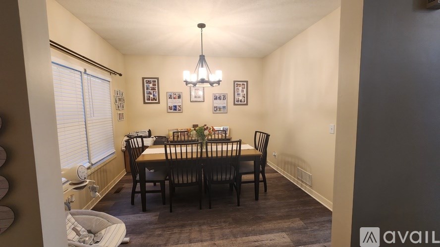 A dining room with a table set for six people.