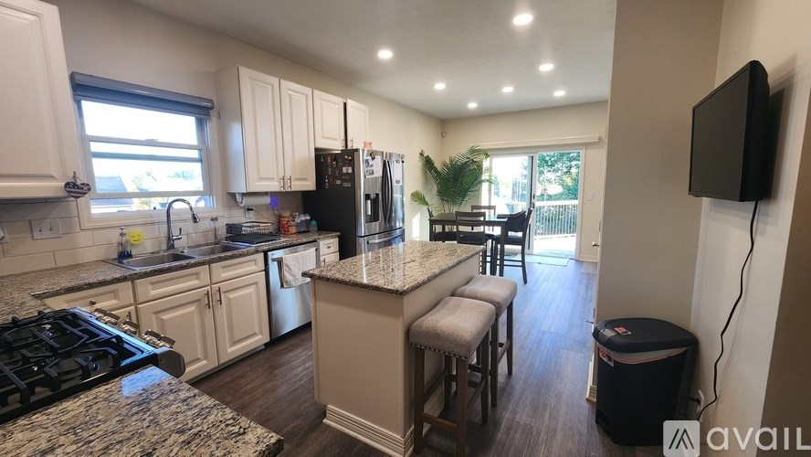 A kitchen with granite countertops and stainless steel appliances.