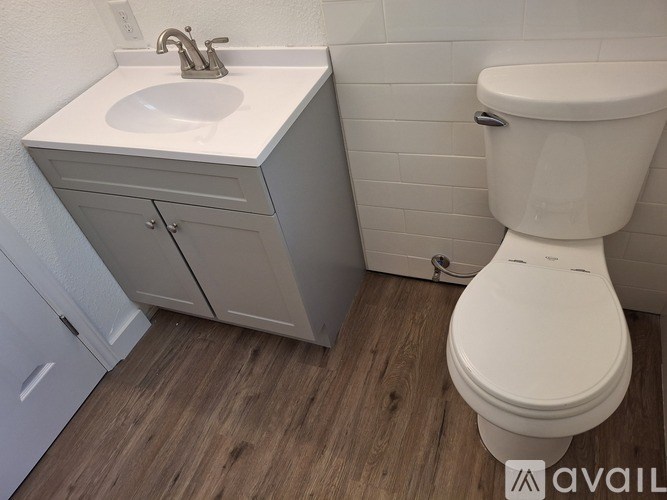 A white toilet sits next to a sink in a bathroom.