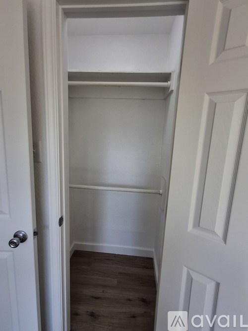 A white door with a silver handle is open.