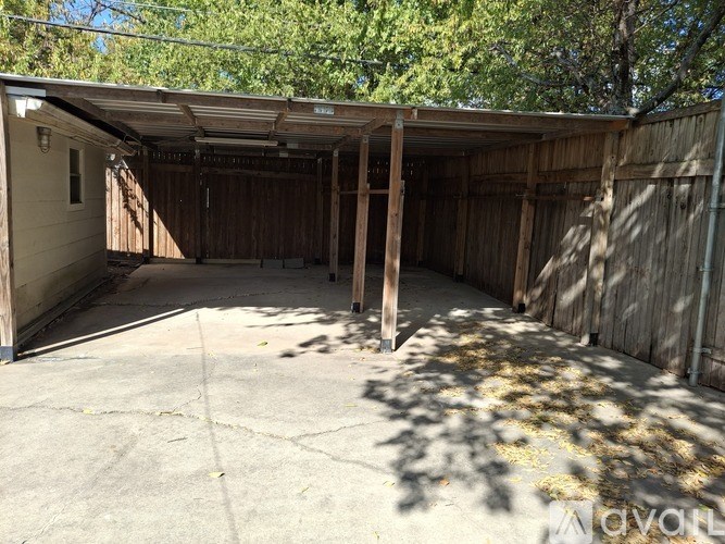 A large, open garage with wooden walls and a concrete floor.