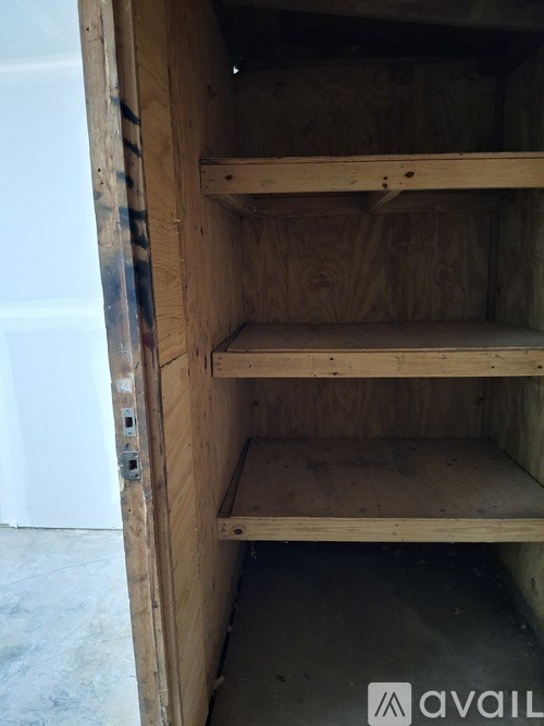 A wooden shelving unit with three shelves is open.