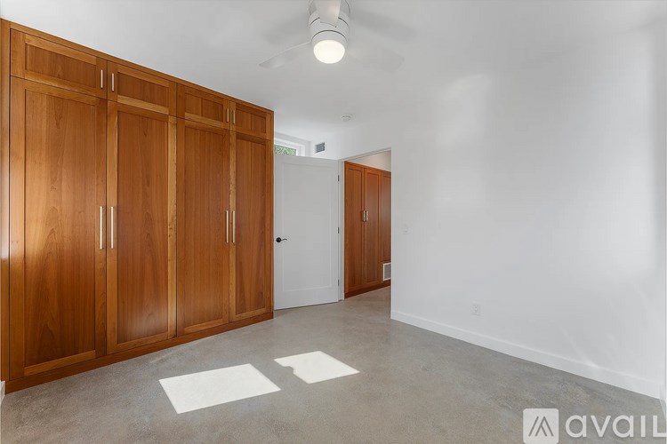 A room with wooden doors and a white ceiling fan.