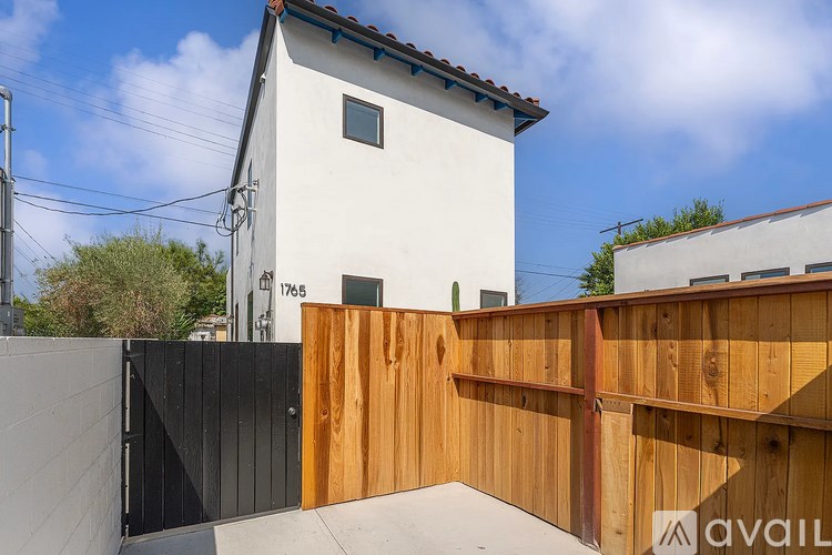 A house with a white exterior and a wooden fence.