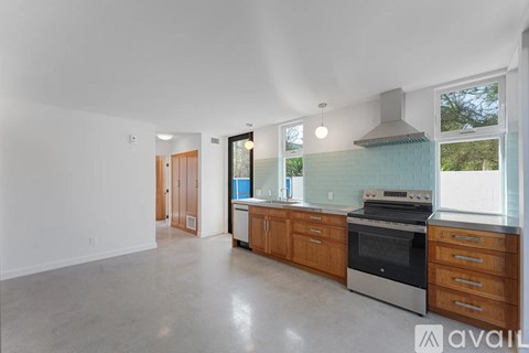 A kitchen with a stove top oven and a sink.