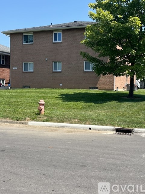 A brick building with a fire hydrant in front of it.