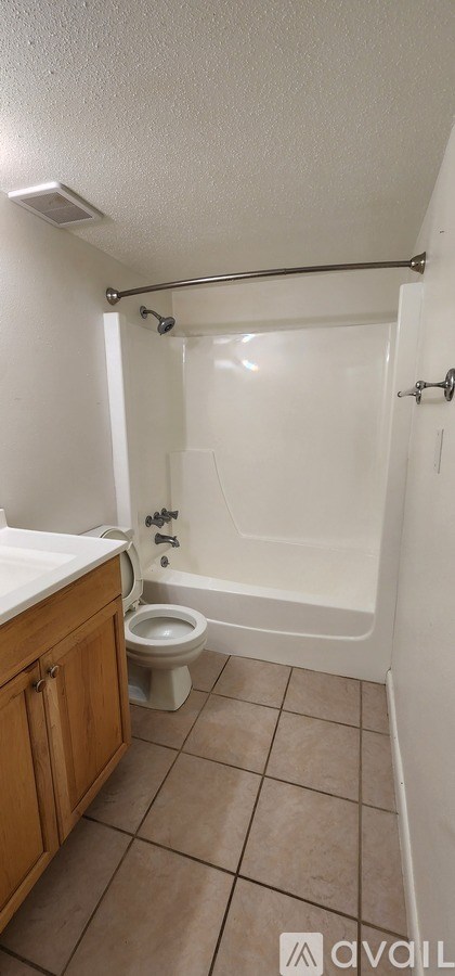 A bathroom with a toilet, sink, and bathtub.
