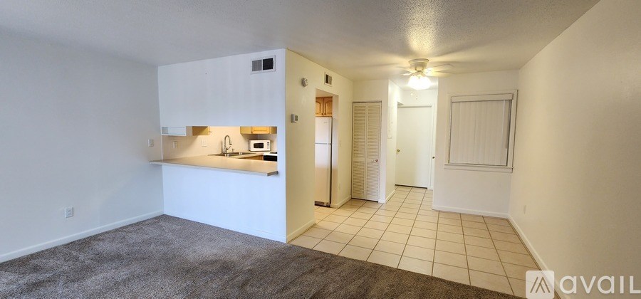 A kitchen area with white cabinets and a countertop.