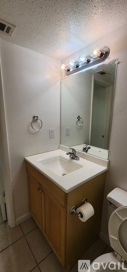 A bathroom with a sink and mirror.