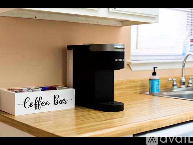 A Kefir coffee bar machine sits on a counter next to a box labeled "Coffee Bar".