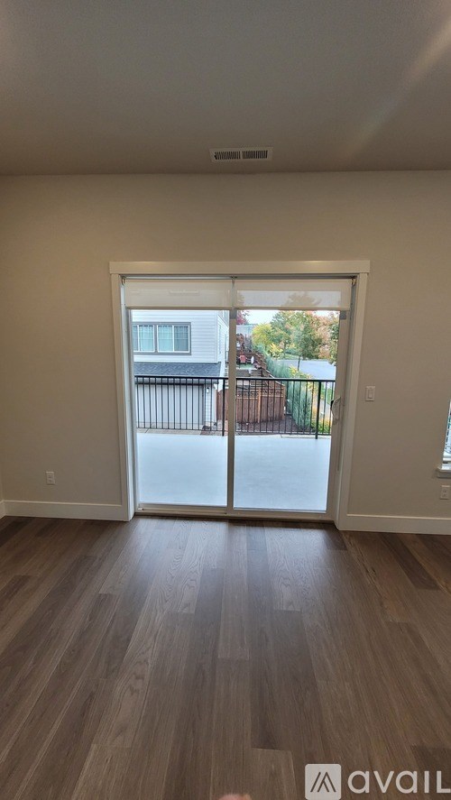 A room with a sliding door leading to a balcony.