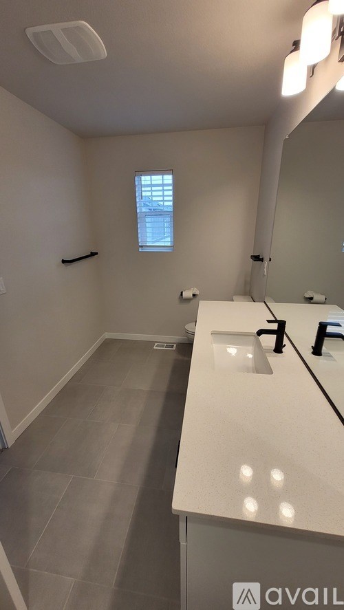 A bathroom with a white counter and a window.