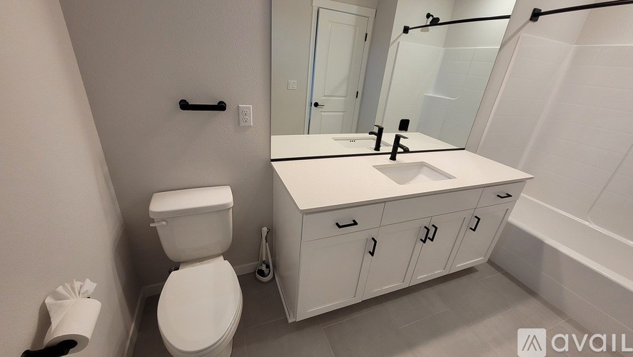 A white toilet sits next to a sink in a bathroom.