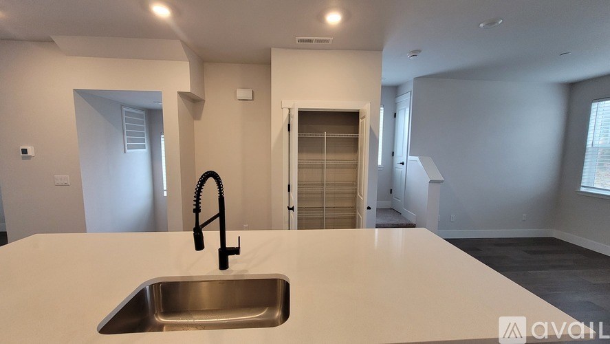 A kitchen with a sink and a window.