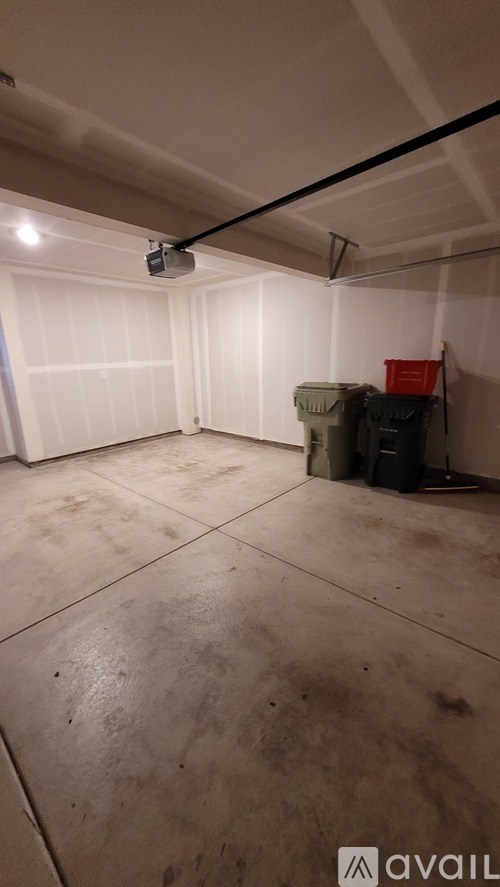 A room with a white ceiling and a black pipe running across it.