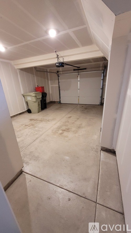 A room with a white ceiling and a white floor with a white wall and a white door.