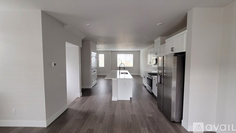 A spacious kitchen with stainless steel appliances and a dining area with a table and chairs.