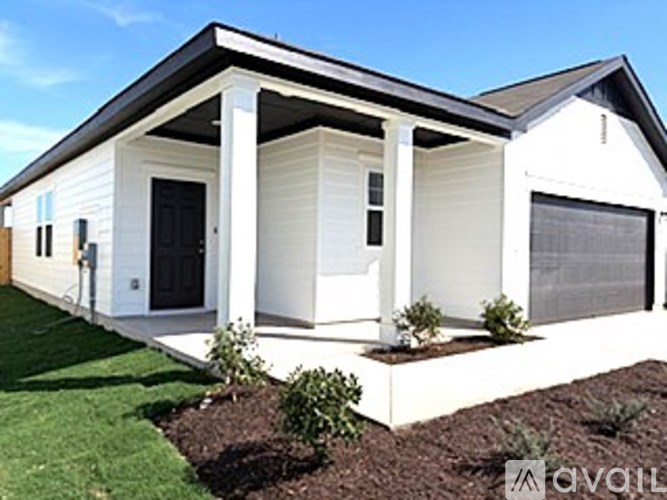 A white house with a black door and windows.