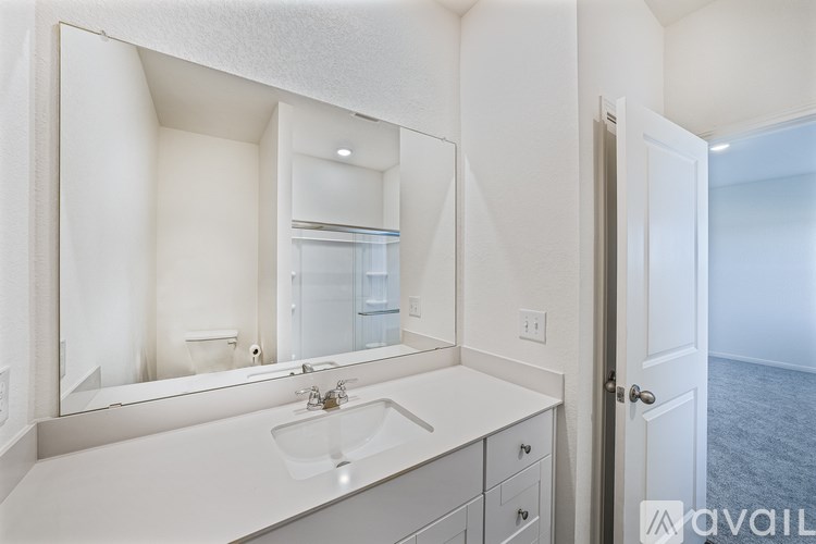 A bathroom with a sink, mirror, and medicine cabinet.