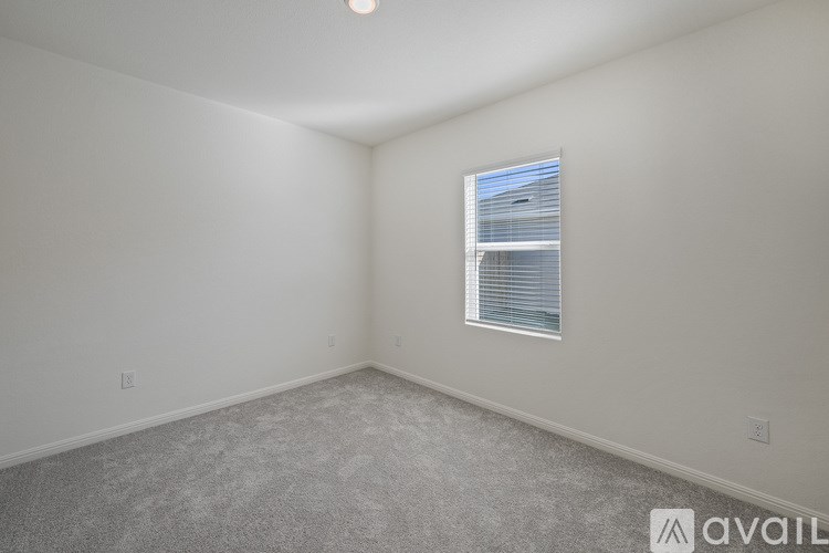 A room with a window and carpeted floor.