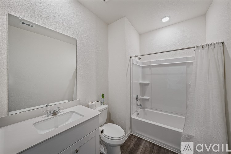 A white bathroom with a sink, toilet, and bathtub.