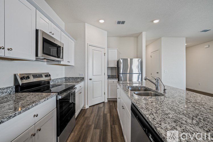A small white house with a covered patio.
