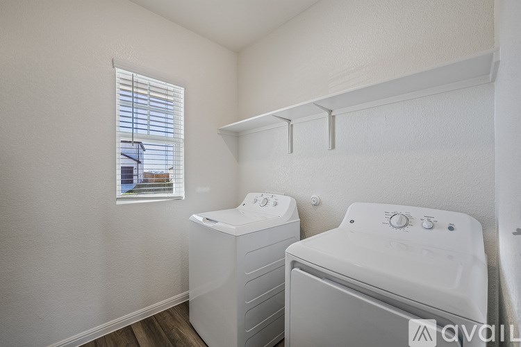 A small laundry room with a washer and dryer.