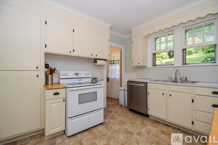 A kitchen with a stove, oven, and sink.