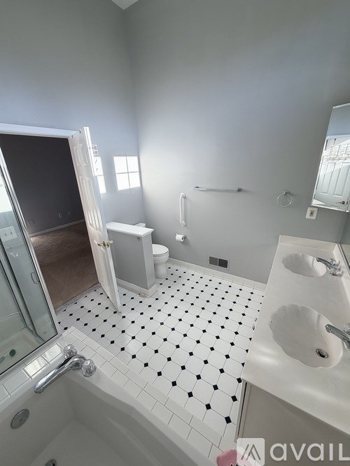 A bathroom with a black and white tile floor.