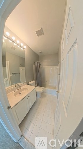 A bathroom with a sink, toilet, and bathtub.