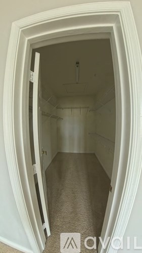 A white doorway opens to a small, empty room.