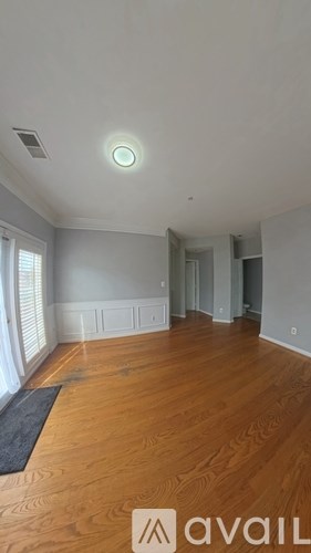 A room with wooden floors and a ceiling light.