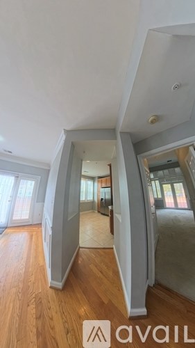 A room with wooden floors and a large mirror on the wall.