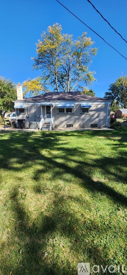 A house with a tree in front of it.