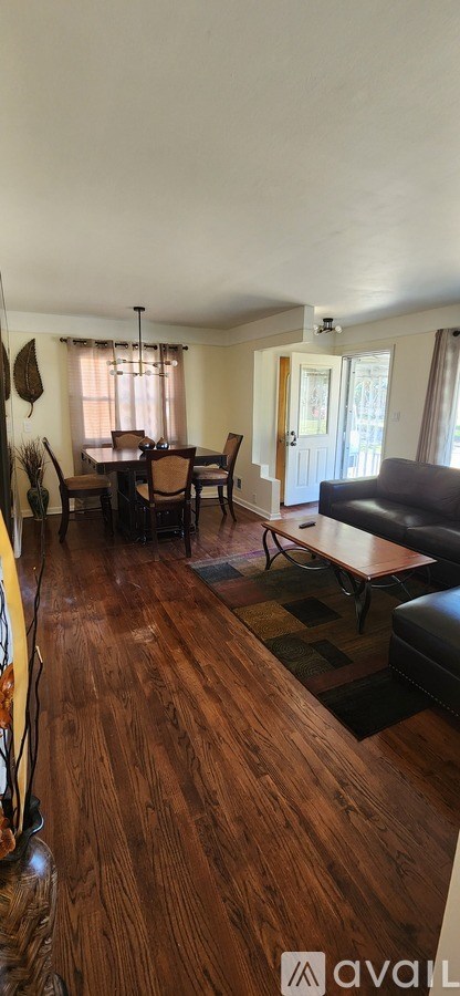 A living room with a couch and a dining table.