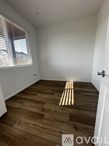 A room with wooden flooring and a light on the floor.