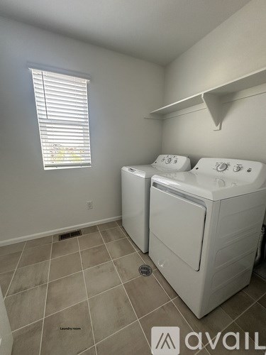 A laundry room with a washer and dryer.
