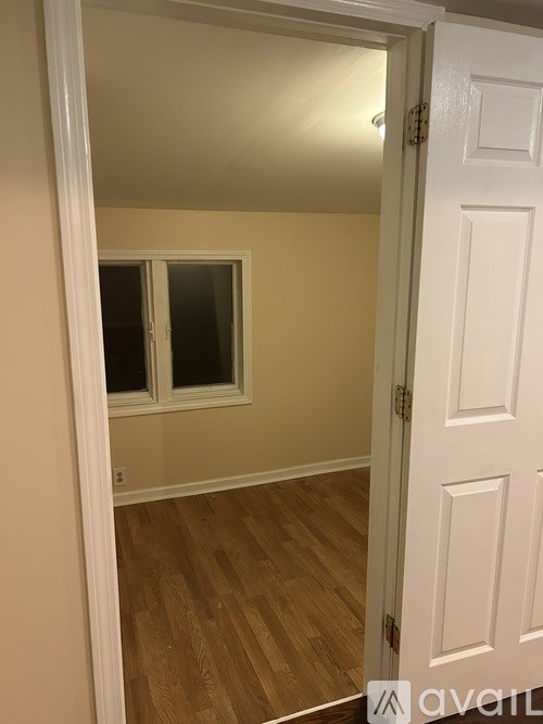 A room with a white door and a window.