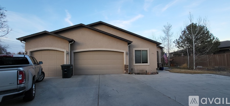 A house with a brown garage door and a silver truck parked in front.