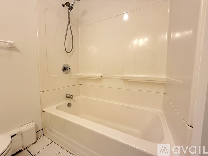 A white bathroom with a tub and shower.