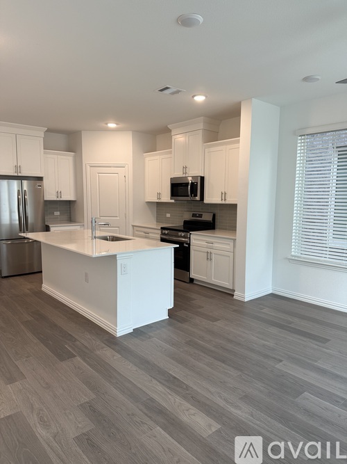 A kitchen with white cabinets and a countertop.